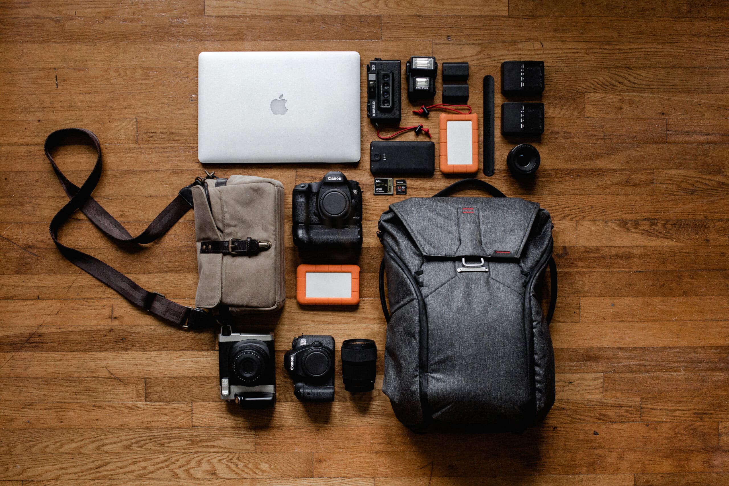 Top view photo gadgets on hardwood floor with a Tech Bag